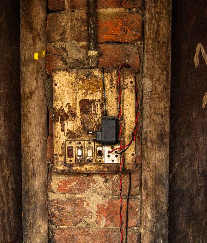 Old fuse box on a brick wall
