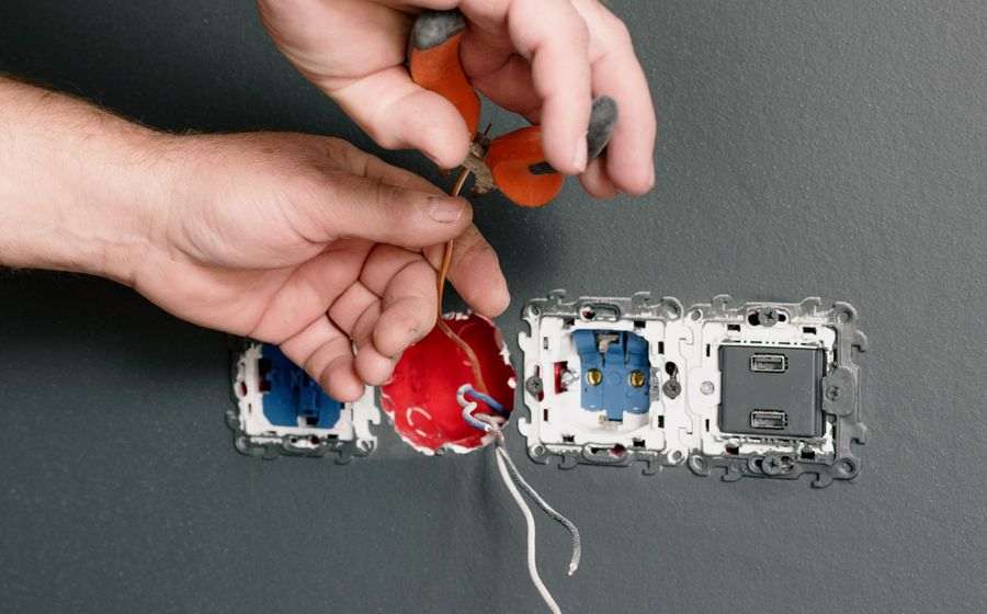 Electrician installing sockets and switches